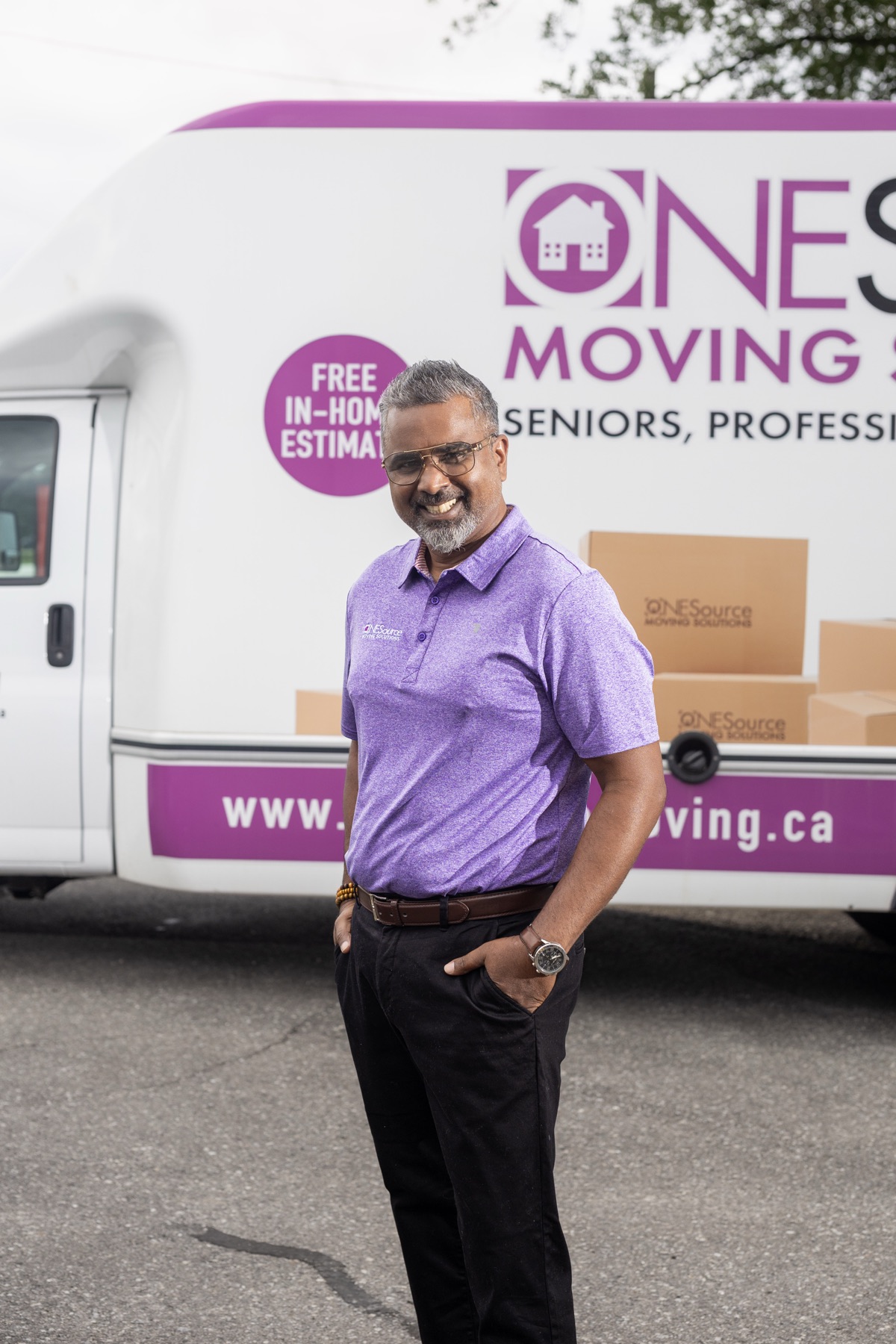 Kerry Rambalie, co-owner of ONESource Moving Solutions Caledon, smiling in a company polo shirt